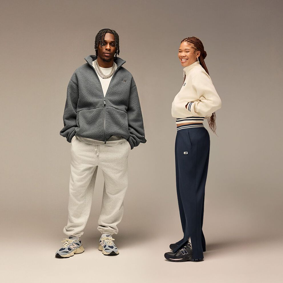 Pile of New Balance sneakers on beige background 
